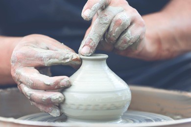 hands of a potter. potter making ceramic pot on the pottery wheel