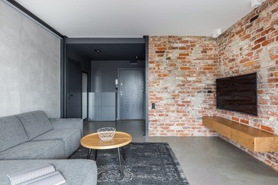 exposed brick wall and concrete floor in industrial living room 