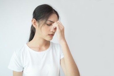 woman touching her head with hands. young asian woman feel headache. isolated on white background.