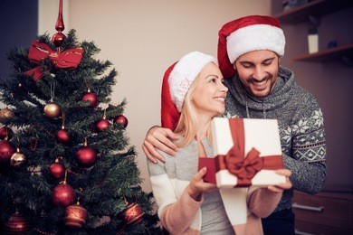 merry christmas. happy young couple celebrating christmas at home.