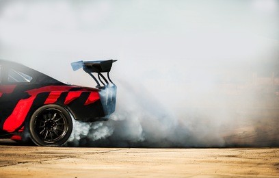 sport car wheel drifting. blurred of image diffusion race drift car with lots of smoke from burning tires on speed track. sport concept,drifting car concept