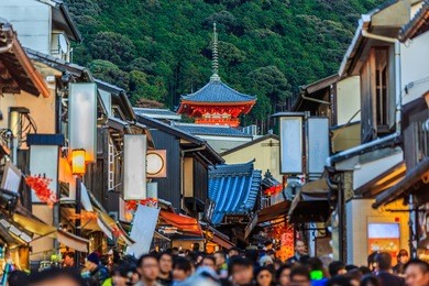 tourists walk on a street leading to kiyomizu-dera temple in kyoto city, kiyomizu-dera is a famous temple in kyoto built in year 778, japan
