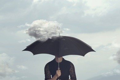 surreal moment of a woman hiding under the umbrella from a small cloud that chases her