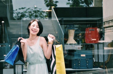 asian woman holding shopping at outlet mall.