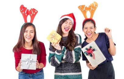group young happy asian woman with santa hat holding gift box present for christmas party and celebration isolated on white background, merry christmas and happy new year concept