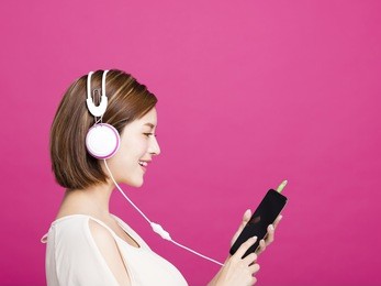 woman listening music with headphones and smart phone
