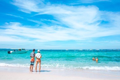 lovers of tourists are enjoying at the sea and the clear sky at koh larn island, pattaya, thailand.