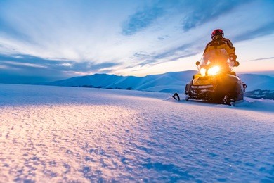a rider on the snowmobile. beautiful winter day in ukrainian mountains. sunset.