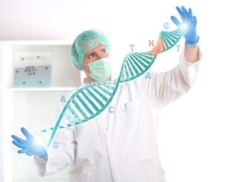 researcher or a medic holding up a dna strand. this could be also futuristic doctor using genetic engineering techniques known as recombinant dna technology.
