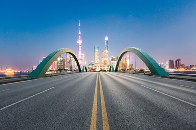 asphalt road and modern city famous architectural scenery in shanghai at night,china