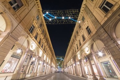 central street with beautiful buildings in turin city in piedmont region in italy, via roma street is the main road in the city center of torino with amazing colorful lights