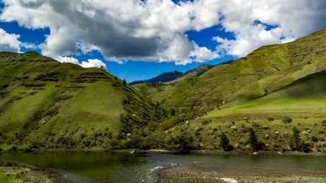 rolling mountains of idaho with blue sky and clouds