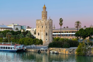 golden tower (torre del oro) at sunset from the other side of the guadalquivir river, seville (andalusia), spain.