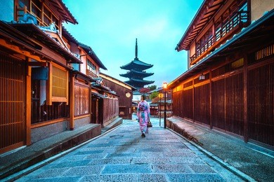 asian woman wearing japanese traditional kimono at yasaka pagoda and sannen zaka street in kyoto, japan.