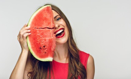 fun portrait of young woman with big piece of watermelon. isolated studio portrait.
