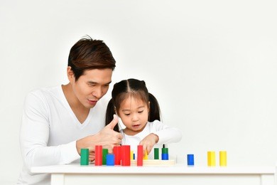 parents are teaching children to do homework.