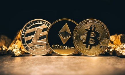 golden cryptocurrencys bitcoin, ethereum, litecoin and mound of gold - business concept image