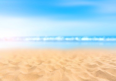 sandy beach with blurry blue ocean