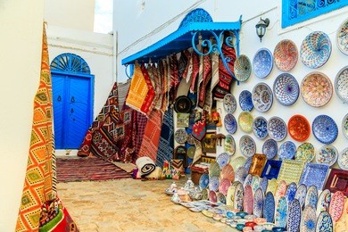 souvenir earthenware and carpets in tunisian market, sidi bou said, tunisia.