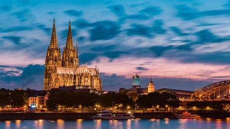 sunset sky with colors and clouds over the city skyline cologne with bridge and köln dom ,evening scene over cologne/koln city with kolner dom/cathedral behind the hohenzollern bridge 