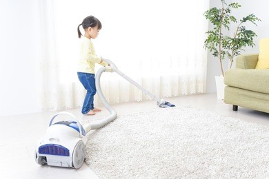 child doing household chores and mother