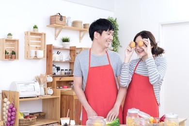 young asian lover or couple cooking very funny, happy and joyful together in kitchen. lifestyle lover at home concept.