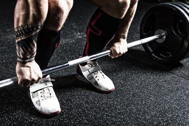 professional powerlifter prepares for deadlift. view from above. mixed media
