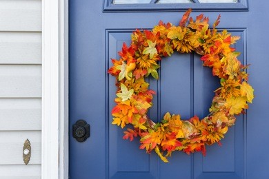 closeup of front door and decorative autumn wreath