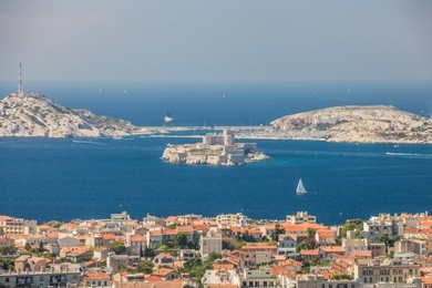 views of marseille and famous if castle, chateau d'if from the church of notre-dame de la garde on a beautiful summer day.
