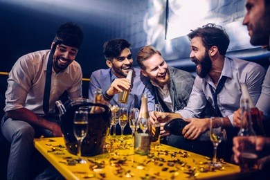 group of young men drinking at a nightclub