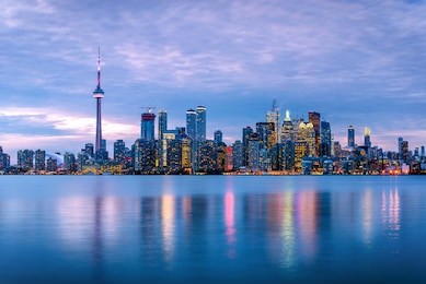 toronto skyline at dusk and reflection in water
