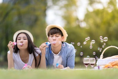 young couple happy playing balloon in the garden