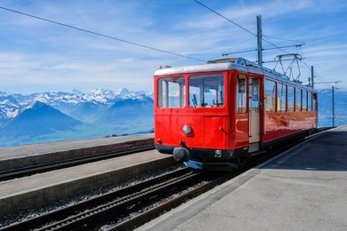 famous electric red tourist swiss train on rigi mountain,switzerland,europe