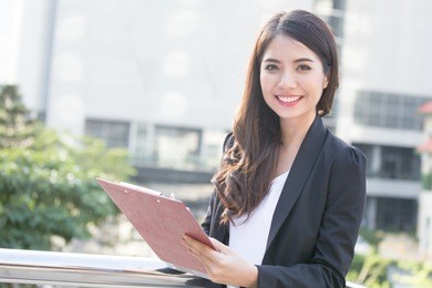 young beautiful business woman standing in city with success feeling for work. young business woman have confident for work with success concept. asian woman success for work.