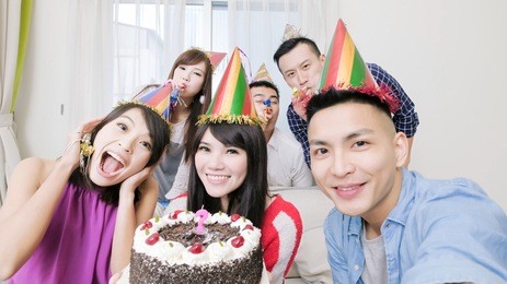 people smile happily with birthday party in the home