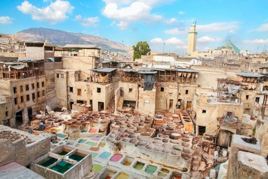  panoramic view of traditional tannery pits in fez old town, morocco.