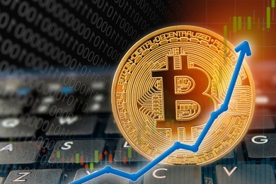 bitcoin currency rising arrow price record highs on keyboard computer with golden bitcoin and other currencies.