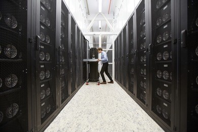 staff of bitcoin storage system service examining hardware in mining farm