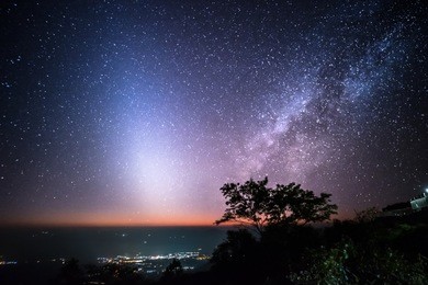 mountains, stars, zodiacal light and the milky way on a beautiful night sky in new day.