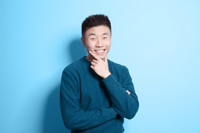 portrait of young asian man on color background