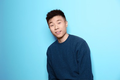 portrait of young asian man on color background