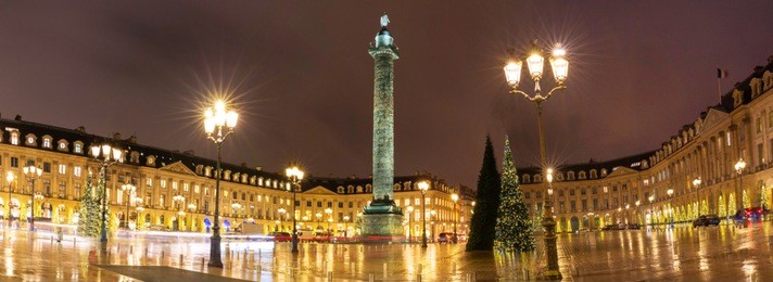the panoramic view of place vendome decorated for christmas at rainy night, paris, france.