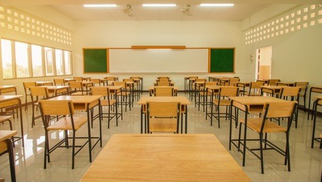 lecture room or school empty classroom with desks and chair iron wood for studying lessons in high school thailand, interior of secondary education, with whiteboard, vintage tone educational concept