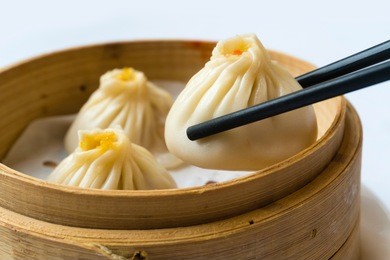 enjoying traditional shanghai dumpling, also called xiaolongbao