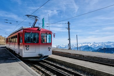 famous electric red tourist swiss train on rigi mountain,switzerland,europe