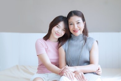 happy family and lovely beautiful mom and teenage daughter spend time together at home , mother's day