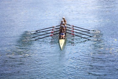 team of rowing four-oar women in boat 