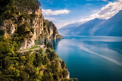 panorama of the gorgeous lake garda surrounded by mountains in riva del garda, italy.