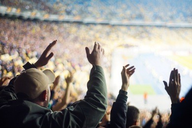 football fans clapping on the podium of the stadium