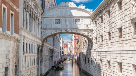 gondolas floating on canal towards bridge of sighs timelapse (ponte dei sospiri). view from bridge ponte della paglia. venice, italy